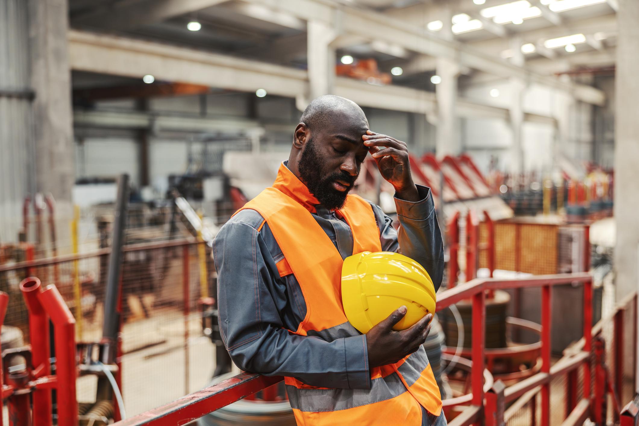 Worker experiencing attentional fatigue on industrial site